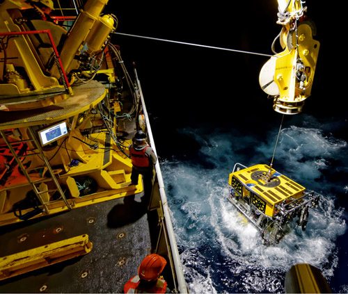 An ROV being lowered into the sea